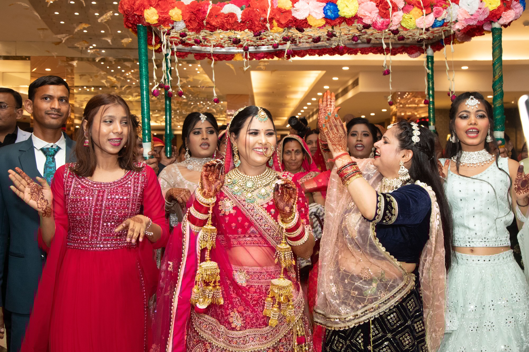Joyful Indian wedding with a bride and guests in traditional attire, dancing and smiling
